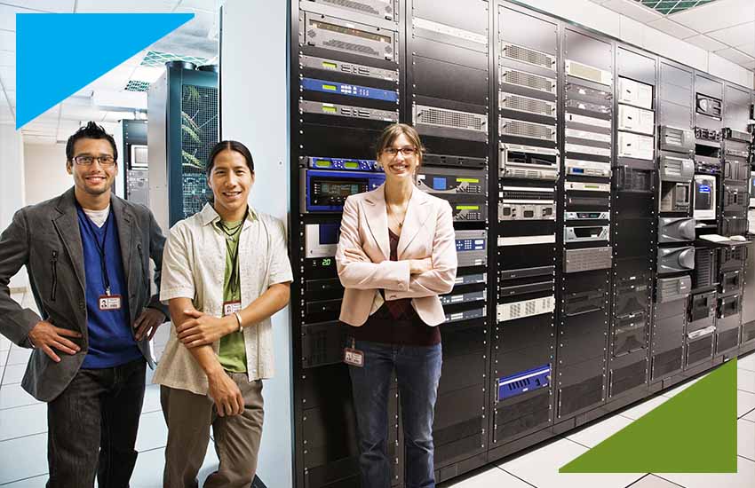 System administrators standing in a secure data center with server racks, representing IT infrastructure management in banking operations.