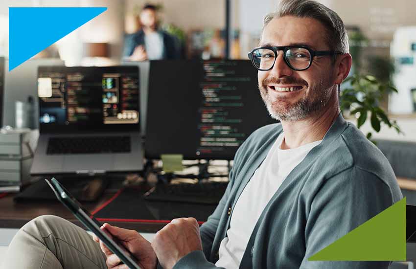 miling IT professional in an insurance company office working on digital systems, representing direct hire IT roles in insurance.