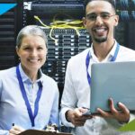 Two IT professionals working together in a server room, representing IT project staffing for insurance operations and digital transformation.