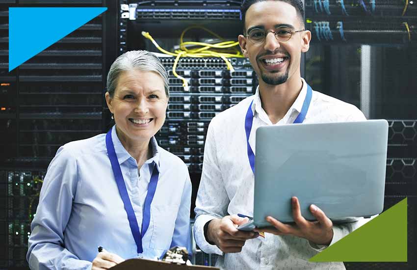 Two IT professionals working together in a server room, representing IT project staffing for insurance operations and digital transformation.